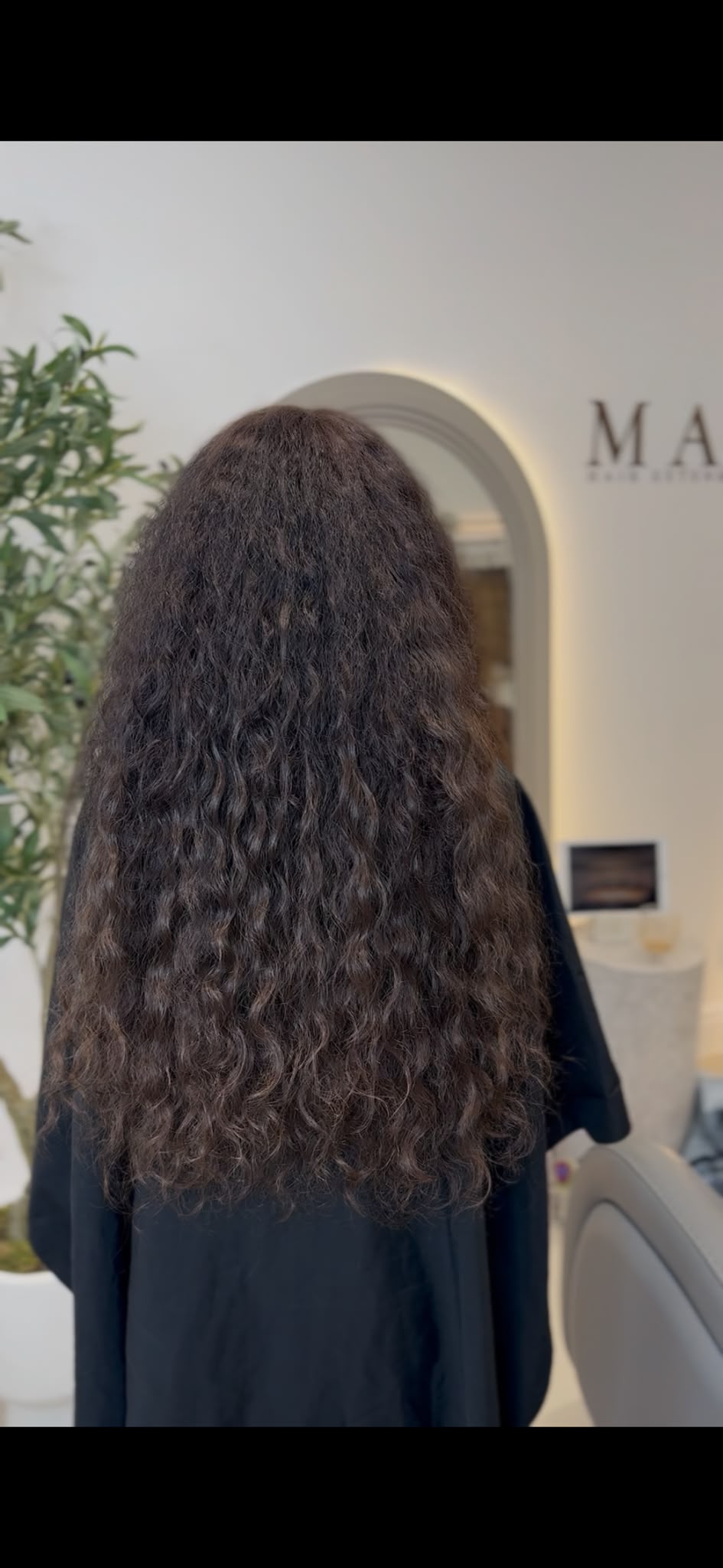 Natural curly extensions photographed air-dried, with no heat styling, showing the curl pattern and shrinkage as it really falls